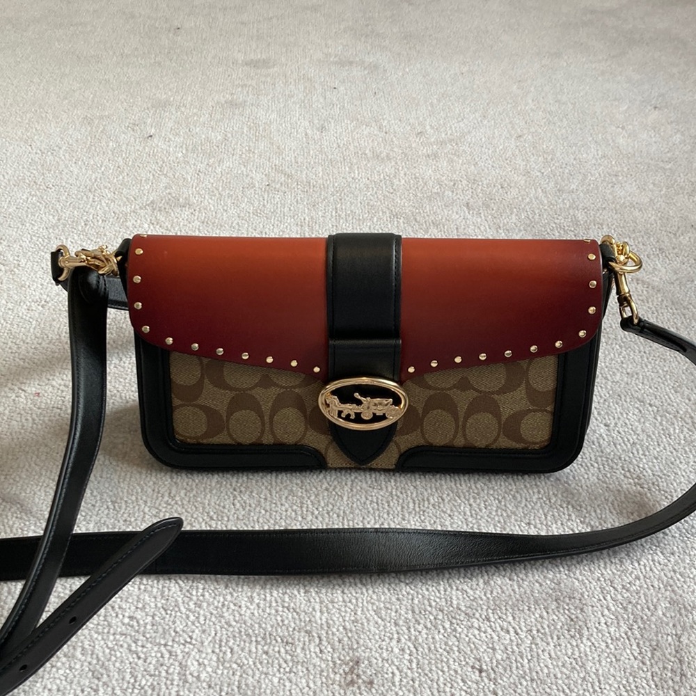 30. NWOT COACH MULTI TONE CLUTCH